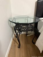 Round glass top side table showing full view