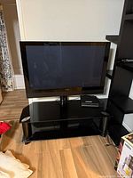 Front view of Pioneer TV on black glass stand