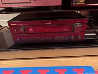 Front angled view of Yamaha HTR-5660 receiver on shelf