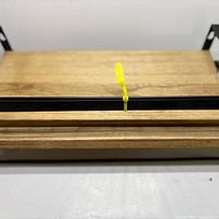 Two stacked wooden shelves with black metal brackets; yellow tie indicates integrated towel bar on top shelf