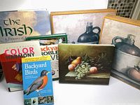 Group shot of four books and three stacked canvas prints