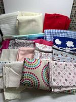 Front view of stacked fabric pieces showing variety of colours and patterns