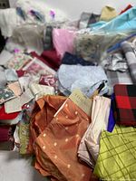 Overview of mixed fabric pieces spread on surface
