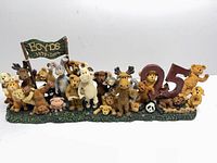 Front view of resin figurine showing animals, large 25 numerals and banner