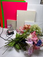 Group shot of poster boards, wood boards, canvas pack, LED base and flowers
