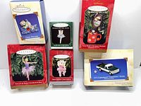 Six boxed Hallmark ornaments displayed