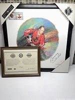 Framed Bobby Hull signed print with COA displayed