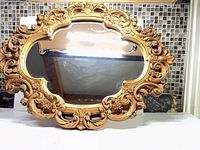 Front view of ornate oval mirror
