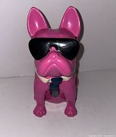 Front view of pink bulldog cookie jar with sunglasses and tie