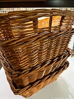stack of four rectangular woven rattan baskets showing overall appearance