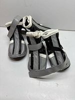 Four gray and black dog boots shown from side view