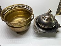 Brass bowl and silver-plated covered dish side by side