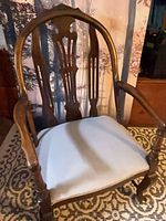 Full front three-quarter view of wooden armchair