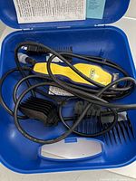 Wahl clipper, cord, guide combs, manual inside blue carry case