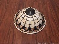 Top view of stained glass lamp shade showing geometric pattern and metal fitting.