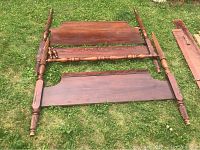 Photo showing mahogany footboard, headboard, and side rails laid out on grass, displaying wood grain and construction details