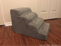 Grey suede four-step portable pet stairs viewed from the front angle showing step design and fabric texture.