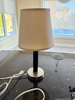 Full view of lamp on countertop showing base, stem, shade, and cord