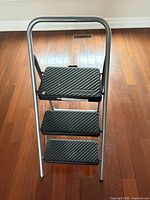 Front view of ladder showing three steps and Cosco logo