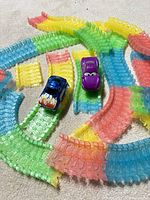 overview of track pieces arranged in a spiral with both toy cars