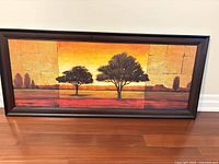 Framed landscape canvas print showing entire artwork with dark wood-look frame