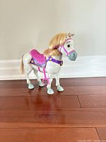 Full side view of Maximus toy horse showing saddle and bridle