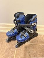 Full view of both skates side by side showing color, wheel count, and closures