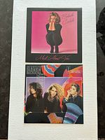 Front view of both vinyl record sleeves—Belinda Carlisle “Mad About You” and Bananarama “Wow!” displayed on white background