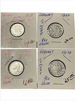 All four coins in holders showing obverse sides and handwritten details