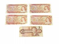 Obverse of five Canadian $2 bills showing design details and condition