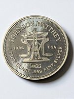 Obverse showing Johnson Matthey name, scale design, 1986, 1 Troy Ounce .999 Fine Silver legend