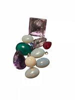 mixed gemstones laid out on white background