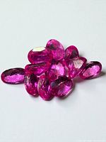 Group of 11 pink sapphires on light background