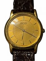 Front view of the Seiko watch showing gold dial, case and strap