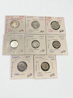 All seven coins in holders, overview