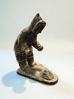 Front angled view of soapstone Inuit figure on base