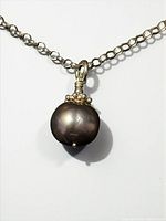 Close view of black cultured pearl pendant on sterling chain