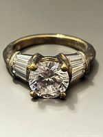 Front view showing round center stone and baguette shoulders