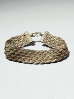 Close view of braided sterling silver bracelet in curved position