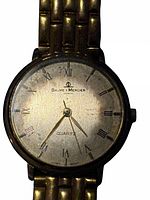 Front close-up of watch dial showing brand, numerals and hands