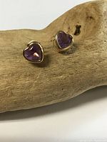Front view of both heart-shaped amethyst gold stud earrings