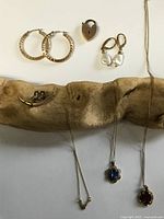 Full group view: earrings, padlock, pearl drops, brooch, two necklaces