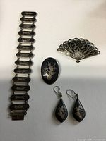 Full view of bracelet, both brooches and earrings