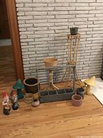 Group shot of all garden decor items against brick wall