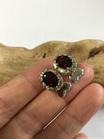 Front view showing red stones, crystal halo and heart accents