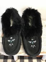 Top view showing both moccasins with fur collar and beadwork