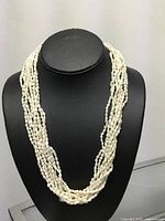 Necklace displayed on bust showing multi-strand design
