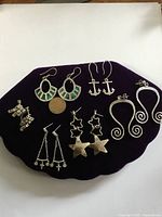 Full lot of earrings on purple pad