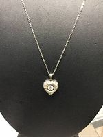 Full view of necklace displayed on bust showing chain length and pendant shape