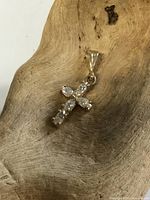 Front view of 10K gold cross pendant with crystals